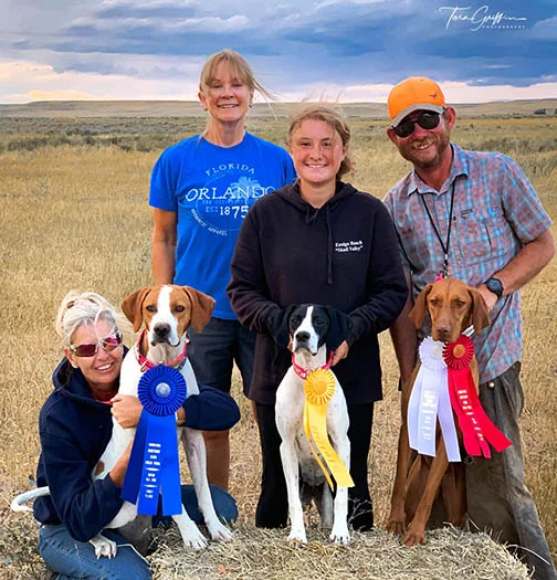 Hunting dogs, their owners, ribbons, and trainer Emmet